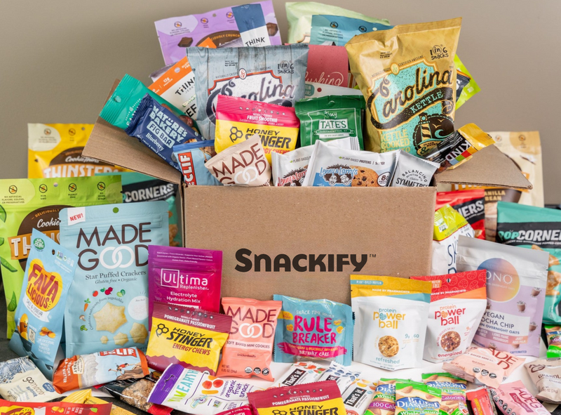 Load image into Gallery viewer, Assorted snack packets in front of a Snackify box on a neutral background
